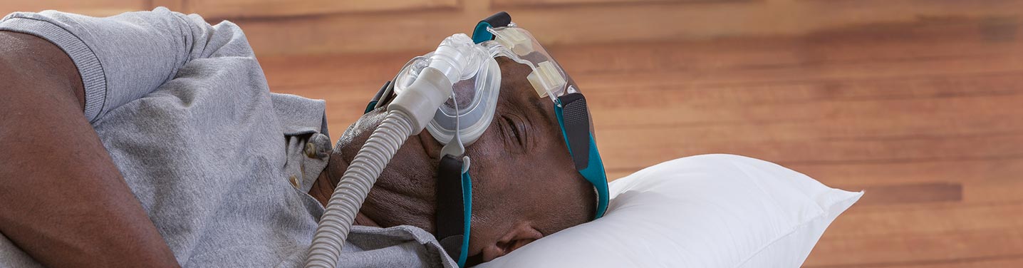 Man sleeping soundly with a CPAP machine